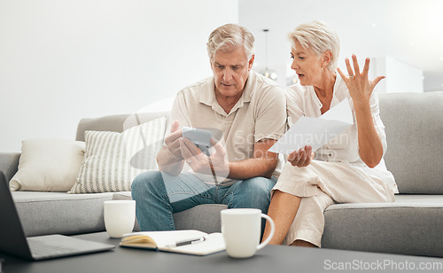 Image of Frustrated senior couple, documents and financial crisis on living room sofa in debt, expenses or bills at home. Mature man and woman checking finance, paperwork or budget with calculator for invoice