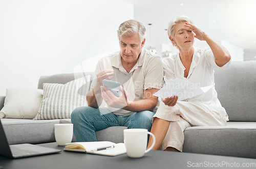 Image of Frustrated senior couple, documents and debt on living room sofa in financial crisis, expenses or bills at home. Mature man and woman checking finance, paperwork or budget with calculator for invoice