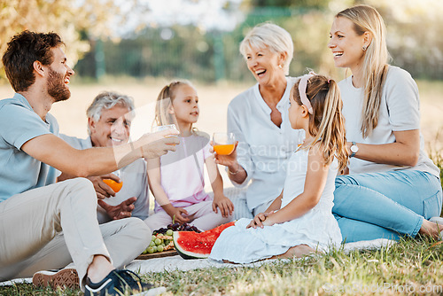Image of Park picnic, laughing and family children, parents and grandparents drinking orange juice, nature and funny joke. Grass field, grandpa and relax senior grandma, father or mother bond with garden kids