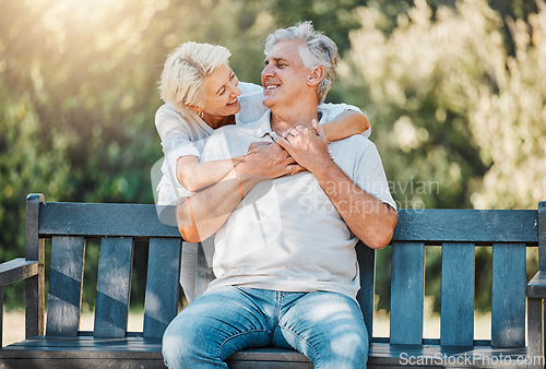 Image of Happy couple, senior and hug on park bench for love, support and bonding together in retirement and nature garden. Smile, relax and elderly woman embrace man in Australia backyard for marriage trust