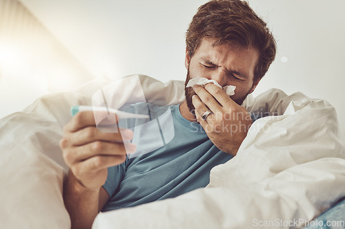 Image of Man, blowing nose and sick with allergies, thermometer to check for fever, virus and bacteria with health fail at home. Toilet paper, healthcare crisis with medical condition and monitor temperature