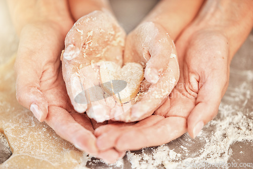 Image of Hands, baking and heart with mother, kid and bonding together as daughter, learning or helping. Family, love and child development with quality time, baker and dough with skills, support and teaching