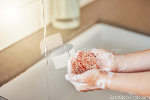 Image of Water, washing hands and kid with foam for cleaning, hygiene and wellness in bathroom at home. Health, child development and palms of young girl with soap for protection for germs, virus and bacteria
