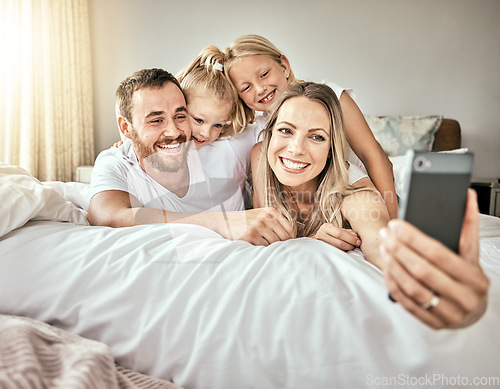 Image of Selfie, happy and portrait of family on the bed for bonding and relaxing together at modern home. Smile, love and girl children laying and taking a picture with parents from Australia in bedroom.