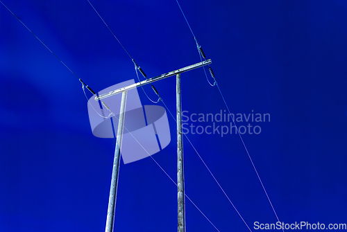 Image of blue night sky with power lines on old wooden poles