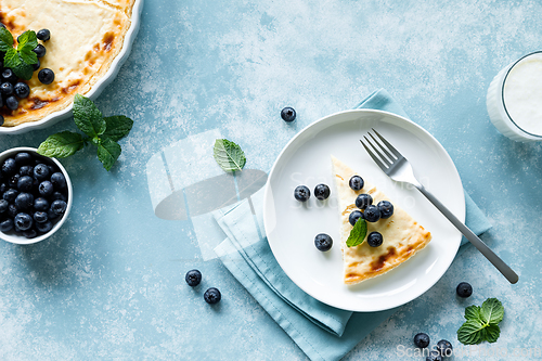 Image of Cottage cheese cheesecake slice with fresh blueberry, top down view