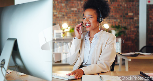 Image of Woman, call center and computer in night, office and talking for telemarketing, voip mic or contact us. African consultant, crm and tech support agent for customer care, ideas or advice at help desk