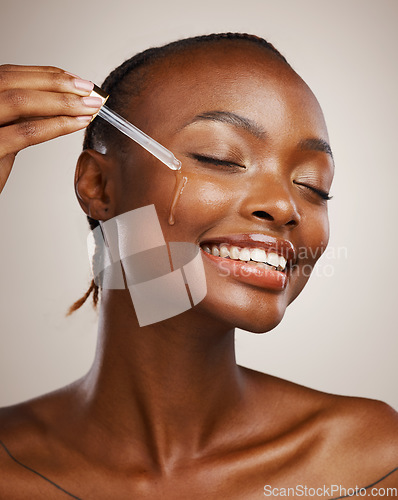 Image of Skincare, woman and smile with dropper on studio background for wellness in cosmetics, beauty or serum. African, person or model by happy, face or relaxed for facial treatment for anti aging oil