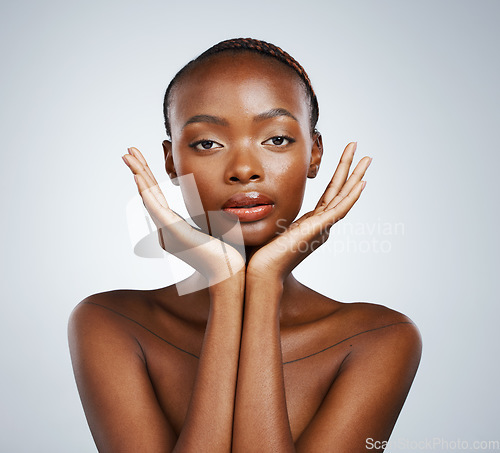Image of Portrait, skin and hands of a black woman in studio on a gray background for skincare, beauty or natural wellness. Face, spa or luxury and a young model with cosmetic or antiaging aesthetic treatment