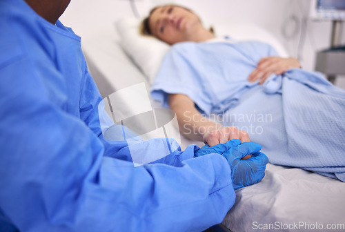 Image of Woman, hospital bed or patient with hand holding, medical and health issue with doctor, sick or virus for support, care and help. Conversation, diagnosis and medicine with healthcare, scared or trust