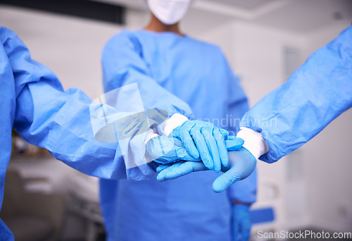 Image of Doctor, team and hands together for motivation, collaboration or unity in surgery room at hospital. Closeup of medical group piling in teamwork for healthcare planning, trust or support at clinic