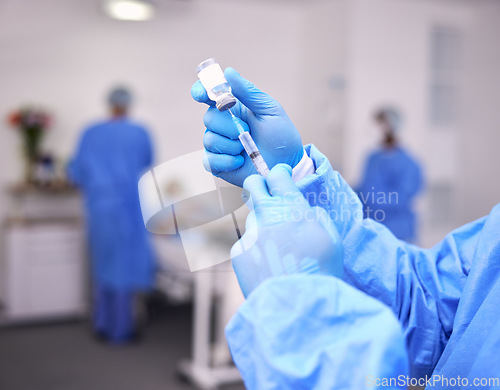 Image of Hands, healthcare and syringe with a doctor in scrubs at the hospital for treatment of disease. Medical, injection and needle with a medicine professional or surgeon getting ready for an operation