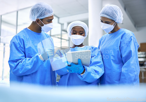 Image of Doctor, tablet and meeting with mask in planning or collaboration for surgery ideas at hospital. Group of medical employees with technology in teamwork, consulting or healthcare strategy at clinic