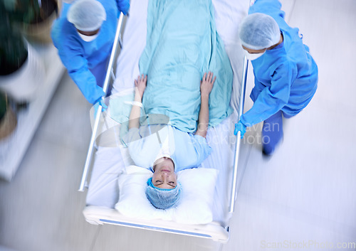 Image of Doctors, team and hurry with bed in hospital for medical emergency, surgery operation or helping from above. Healthcare group running fast in rush, motion blur and urgent patient assessment in clinic