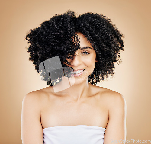 Image of Hair, curls and portrait of woman, beauty and treatment for shine, cosmetic care and smile on studio background. Wellness, haircare and growth with strong texture and shake locks, volume and afro