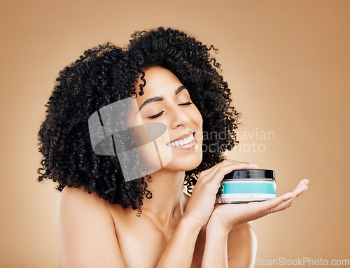 Image of Happy woman, container and hair, product for curls and shine, beauty with smile and strong texture on studio background. Advertising, haircare cosmetics for growth and cosmetology with model and afro