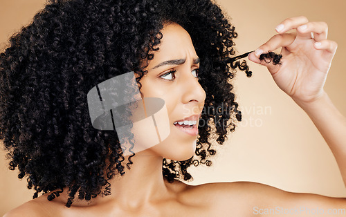 Image of Hair care, afro and face of woman with problem, anxiety or worried about grooming mistake, beauty salon treatment or damage. Haircut disaster, broken dry strand and model stress on brown background