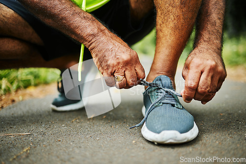 Image of Man, tie and shoes in fitness for running, workout or outdoor exercise on road, street or asphalt. Closeup of male person, hands and tying shoe getting ready or preparation for sports, cardio or run