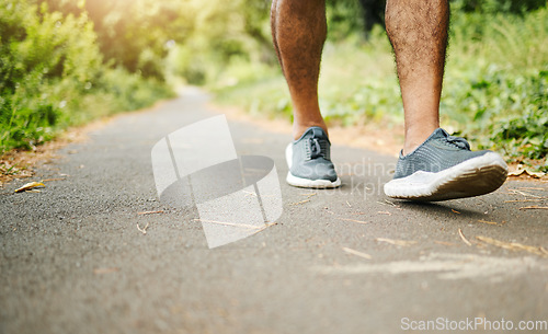 Image of Man, legs and fitness on road for hiking, workout or walking in outdoor exercise or wellness in nature. Closeup of male person, shoes or feet on path for trekking, training or cardio on asphalt