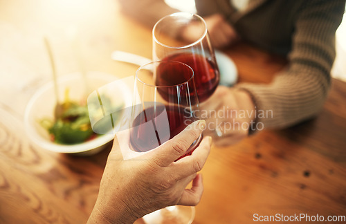 Image of Glasses, closeup and couple with wine, cheers and celebration with lunch, bonding and love. People, man and woman with alcohol, toast or home with achievement, anniversary or marriage with gratitude