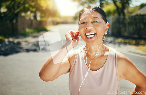 Image of Fitness, music earphones and portrait of Asian woman outdoor for sports training, exercise and healthy body. Happy face, mature athlete listening to radio in street and excited for streaming podcast