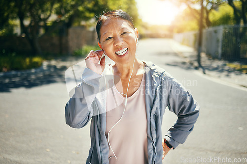 Image of Fitness, earphones and portrait of happy Asian woman outdoor for sports training, exercise and healthy body. Face, mature person listening to music in street and streaming audio podcast to workout