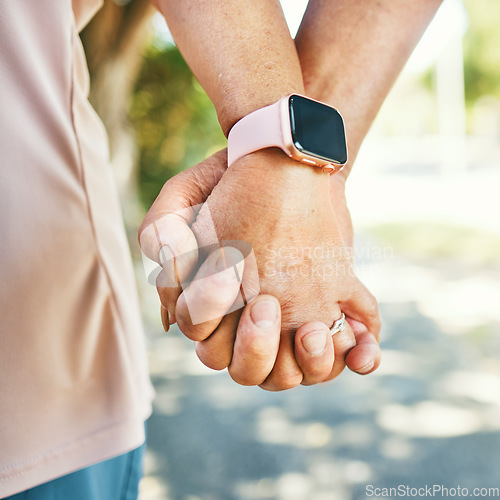 Image of Closeup, holding hands and support with trust for love in bond, together or romance while walking. Elderly couple, man and woman in retirement with exercise for wellness, health or smart watch