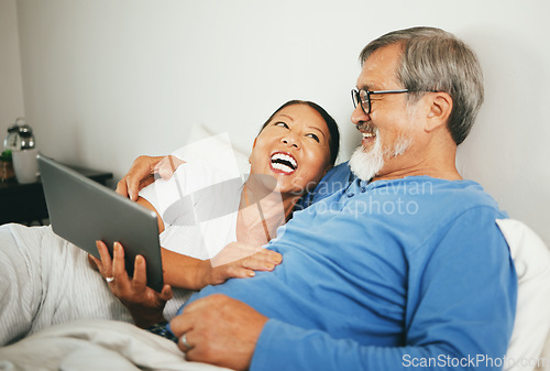 Image of Tablet, mature or happy couple in bed for movie watching on website subscription via internet connection. Meme, home or mature woman laughing at comedy with an Asian man streaming film on tech online