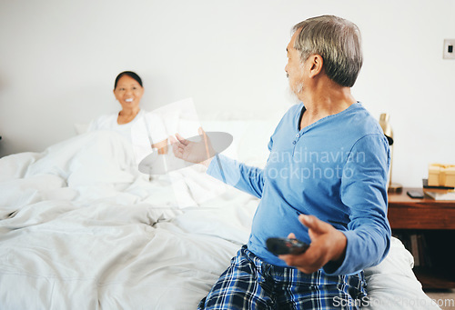 Image of Happy senior couple, watching tv and bed for weekend, retirement or relax together at home. Man and woman with remote for online streaming, entertainment or enjoying holiday honeymoon in bedroom