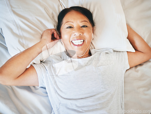 Image of Bedroom face, music and relax happy woman sleeping, tired or nap for break, morning wellness or streaming audio podcast. Happiness, radio sound and top view person smile, rest and comfort on home bed