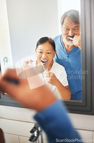 Image of Senior couple, brushing teeth and mirror in bathroom, hygiene and dental, morning routine at home. Healthy people, wellness and oral care with grooming, toothpaste for cleaning mouth and reflection