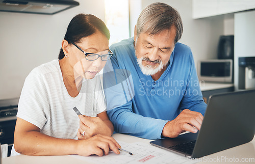 Image of Couple, computer and home documents for finance, loan payment and mortgage planning, bills and invoice in kitchen. Mature woman and man with asset management, life insurance and paperwork on laptop