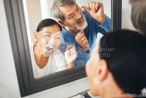 Image of Old couple, flossing in mirror and dental in bathroom, hygiene and teeth whitening during morning routine at home. Fresh breath, orthodontics and reflection with thread, health and oral care