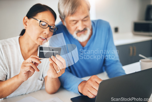 Image of Mature couple, credit card and laptop for home online shopping, loan application or financial management in kitchen. Man and woman with computer for internet banking, security numbers or registration