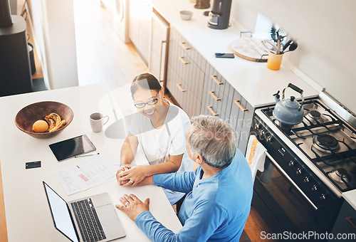 Image of Couple, laptop and home documents for finance, loan payment and mortgage planning, support and love in kitchen. Mature woman and man holding hands for banking and paperwork solution on computer above