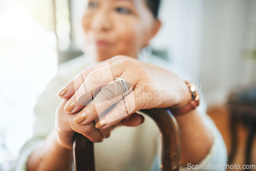 Image of Hands, walking stick and woman in home for support, healthcare and help in retirement. Closeup, lonely widow and senior with disability with cane for parkinson, arthritis and rehabilitation of stroke