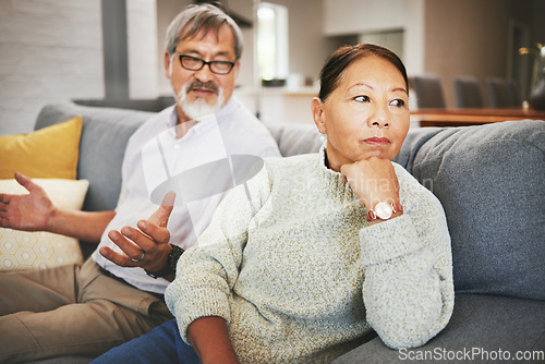 Image of Divorce, fight and mature couple on sofa, conflict and marriage crisis in home. Asian man, woman and argument in living room, stress and angry at relationship fail, frustrated people together and sad