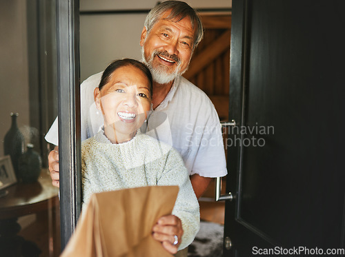 Image of Couple, smile and happiness with front door for food delivery by service to house for retirement. Asian people, elderly and family by together, bond or care with excited on face for e commerce order