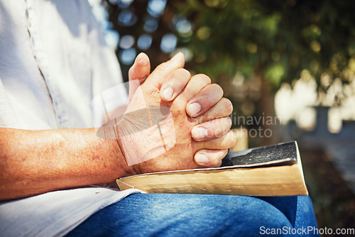 Image of Outdoor, hands and person with a bible, spiritual and believe with prayer, guidance or religion with hope. Christian, closeup or human with scripture, outside or calm with peace, holy book or worship