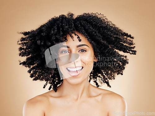 Image of Model, curly and hair wind in afro fun on studio background for healthy hairstyle growth, texture or frizz treatment. African beauty woman, portrait and shake change by shampoo transformation results