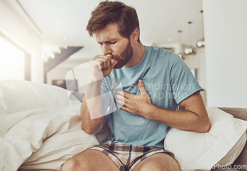 Image of Sick, coughing and man on a sofa with chest pain, tuberculosis or influenza at home. Asthma, anxiety and male person with breathing trouble in living room with covid, pneumonia or lung virus