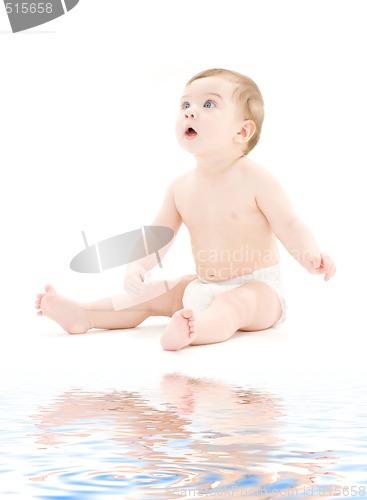 Image of baby boy in diaper with toothbrush