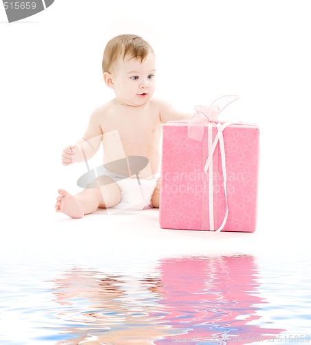 Image of baby boy in diaper with big gift box