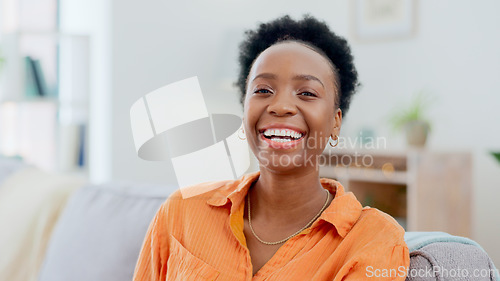 Image of Portrait, funny and a black woman laughing on a sofa in the living room of her home to relax on the weekend. Face, smile and comedy with a happy young person in her apartment to joke for humor