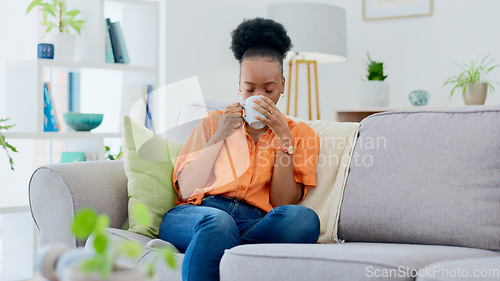 Image of Black woman, home and drinking coffee on sofa, relaxing and smiling for self care, living room and break. Me time, comfort and quality time in house, sofa and day off for rest, laughing and happiness