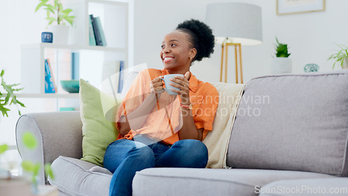 Image of Black woman, smiling and couch with tea, relaxing and cozy home for self care, living room and break. Me time, comfort and quality time in house, sofa and day off for resting, laughing and happiness