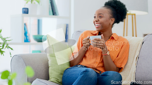 Image of Black woman, house and couch with coffee, relaxing and smiling for self care, living room and break. Me time, comfort and quality time in home, sofa and day off for resting, laughing and happiness