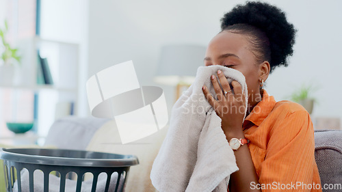 Image of Clean, smell and black woman with laundry in home or basket with clothes, linen or maid spring cleaning in apartment. Fresh, washing and clothing with detergent or cleaner aroma on fabric in house