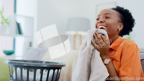 Image of Clean, smell and happy woman with laundry in home or basket with clothes, linen or maid spring cleaning in apartment. Black person, washing or clothing with detergent or cleaner scent on fresh fabric