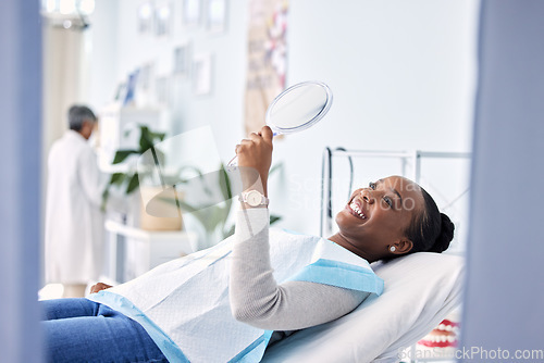 Image of Smile, mirror and black woman at dentist on chair in clinic, tooth treatment and cleaning. Reflection, dental orthodontics and happy person teeth whitening, oral hygiene and healthcare for wellness